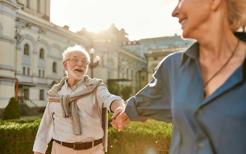 an elderly couple enjoying a nice walk together