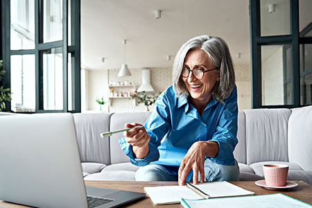 mature woman searches using her laptop senior placement services