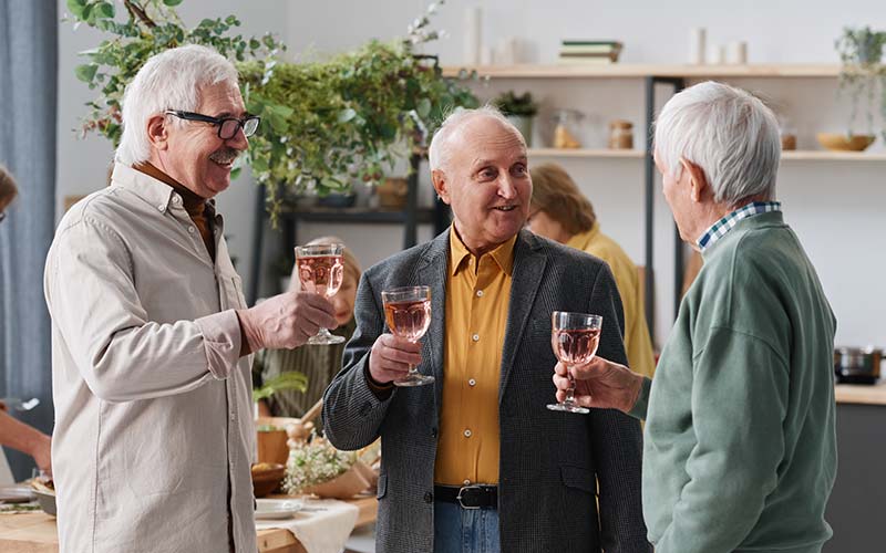 three elderly men drinking mom at an adore social event