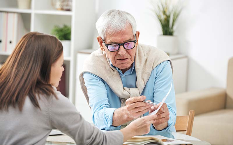 woman helps elderly man understand proactive senior placement options