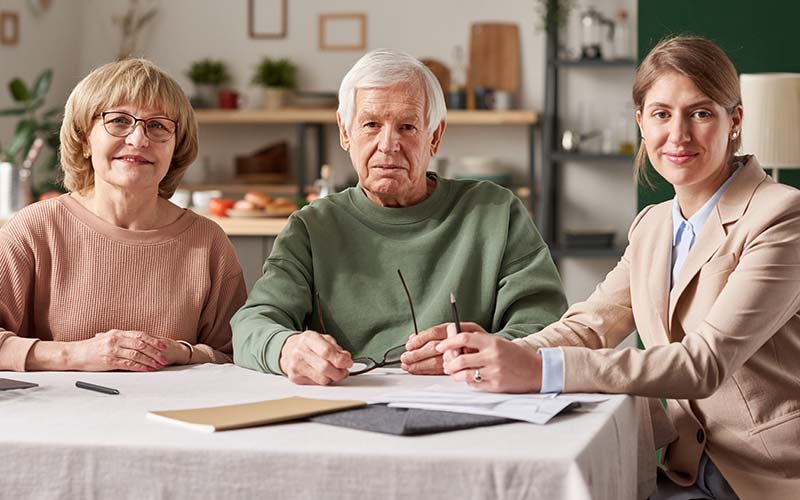 senior real estate specialist compassionately discussing home options with senior couple