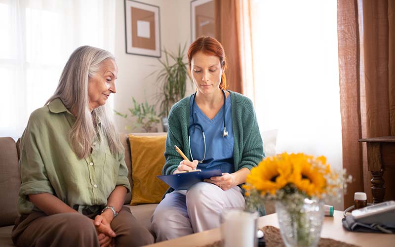 a memory care nurse evaluates a senior woman