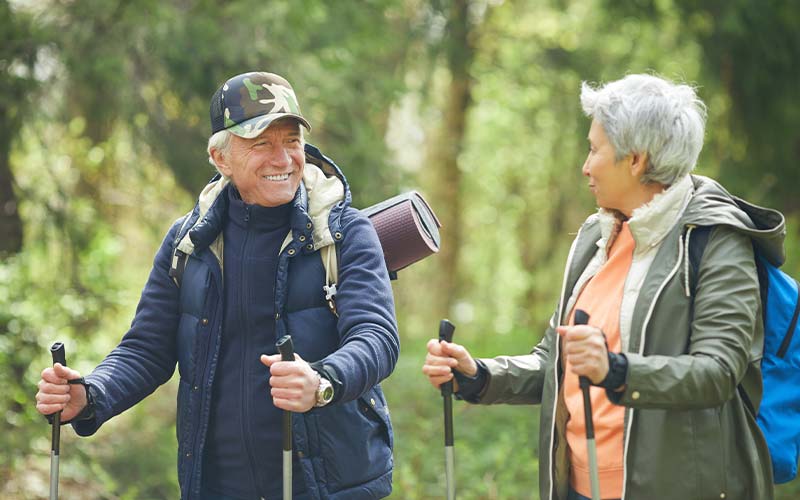 an active senior couple taking a summer hike